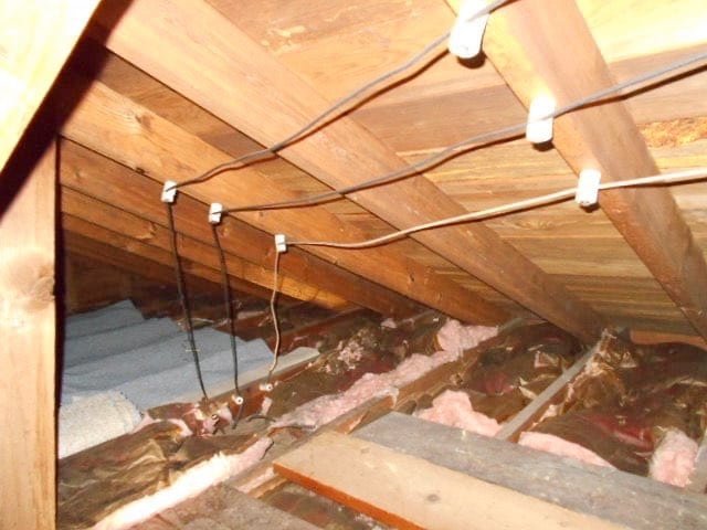 Knob-and-tube electrical wiring installed in an attic of an older home